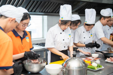 Restaurant and Catering Management students engaged in a signature Bánh mì workshop guided by a culinary expert 75