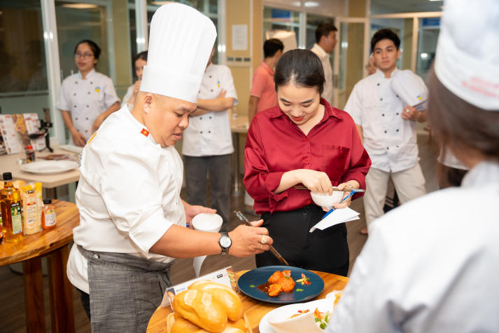 Restaurant and Catering Management students engaged in a signature Bánh mì workshop guided by a culinary expert 89