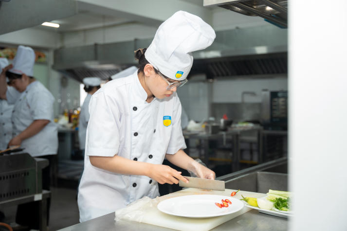 Restaurant and Catering Management students engaged in a signature Bánh mì workshop guided by a culinary expert 85