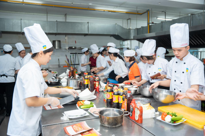 Restaurant and Catering Management students engaged in a signature Bánh mì workshop guided by a culinary expert 73